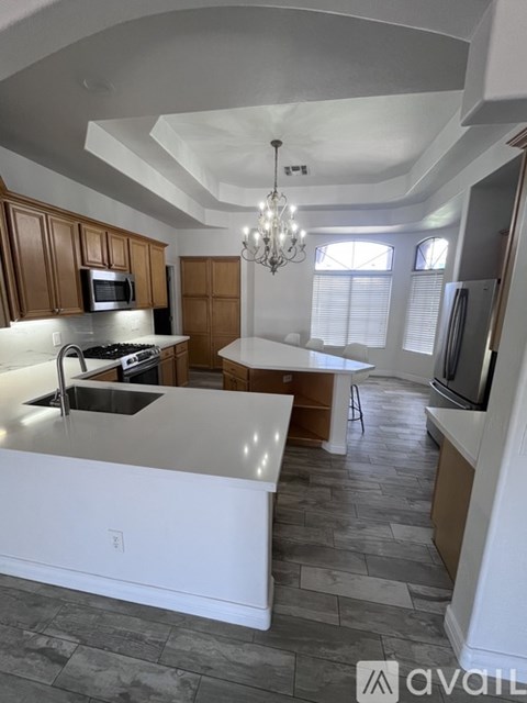 A modern kitchen with wooden cabinets and a central island.