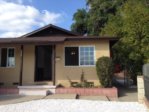 A house with a black front door and a small porch.