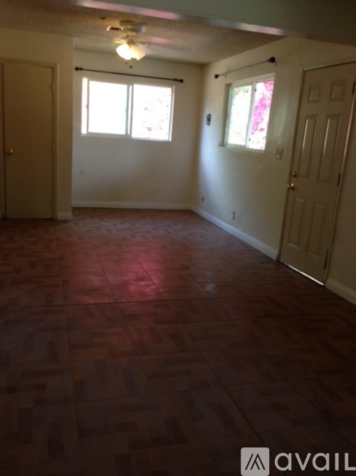 A room with wooden floors and white walls.