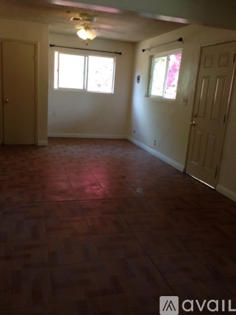 A room with wooden floors and white walls.