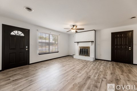 A room with wooden floors and a ceiling fan.