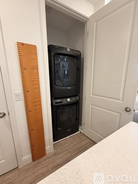 A black oven and microwave are installed in a small kitchen.