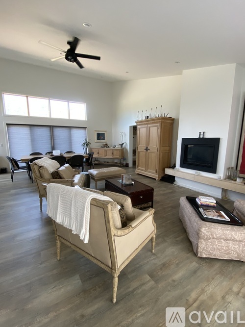 A living room with a beige sofa and a wooden cabinet.