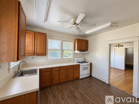 A kitchen with wooden cabinets and a white countertop.