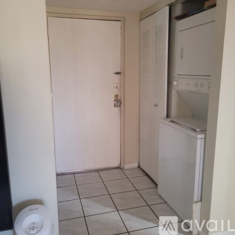 A white door with a key hole in the middle is closed.