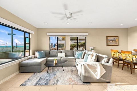 A living room with a grey couch and a coffee table.