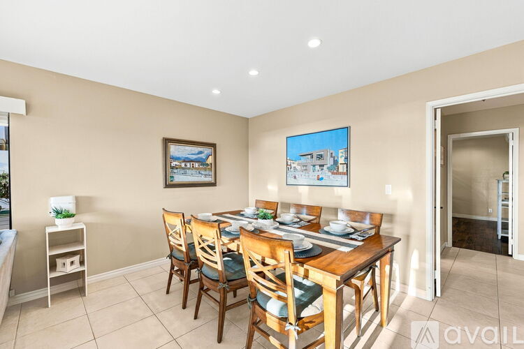 A dining room with a table set for six.