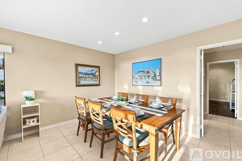 A dining room with a table set for six.