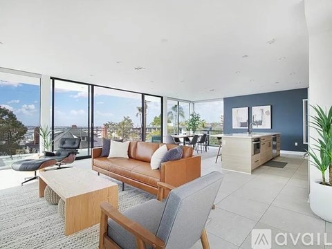 A living room with a brown couch and a grey chair.