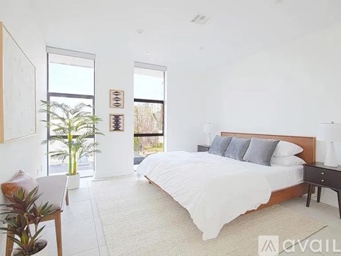 A bedroom with a large bed and a window.