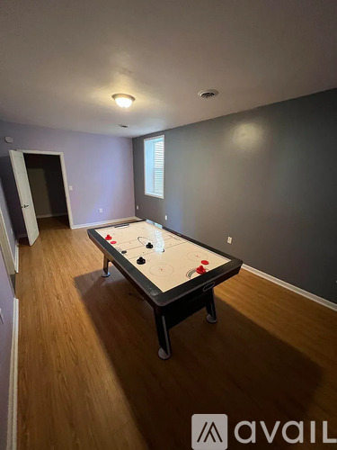 A room with a pool table and a door.