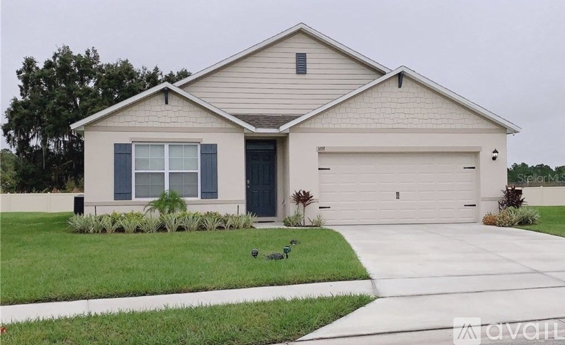A two-story house with a garage and a driveway.