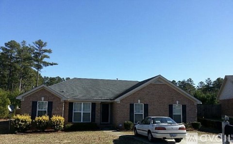 A house with a car parked in front.