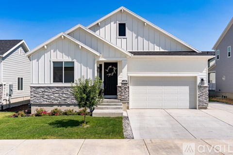 A modern house with a white exterior and a black door.