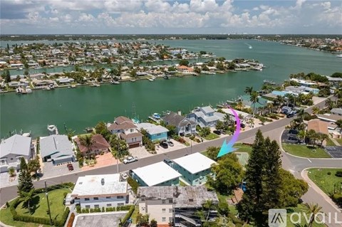 A bird's eye view of a residential area with houses and boats.