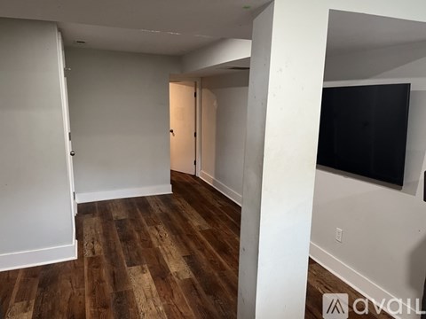 A room with wooden floors and white walls.