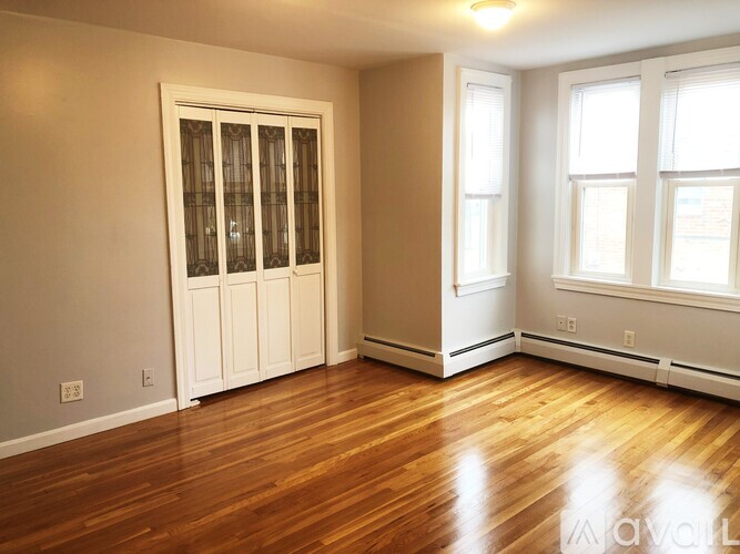A room with wooden floors and white walls.
