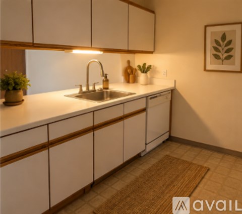 A kitchen with white cabinets and a brown rug on the floor.