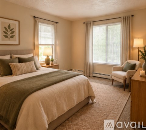 A bedroom with a large bed and a chair.