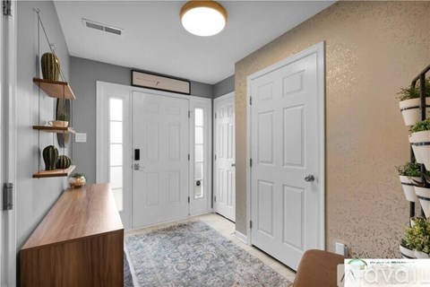 A hallway with a wooden bench, two doors, and a rug on the floor.