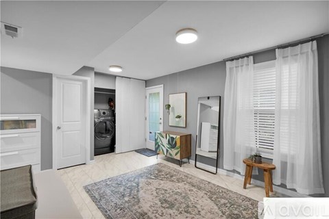 A modern living room with a grey rug and a white curtain.