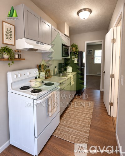 A white stove top oven in a kitchen with a green stove top.