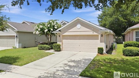 A house with a garage and a driveway is for sale.