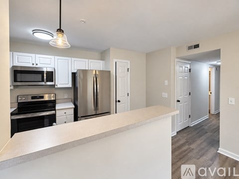 A kitchen with white cabinets and stainless steel appliances.