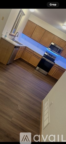A kitchen with wooden cabinets and a stove top oven.