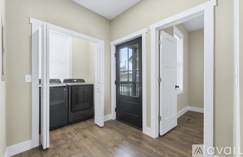 A kitchen area with a black fridge, black oven, and black microwave.
