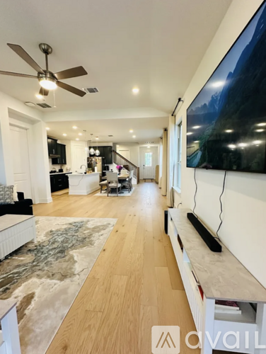 A modern living room with a long marble table and a television on the wall.