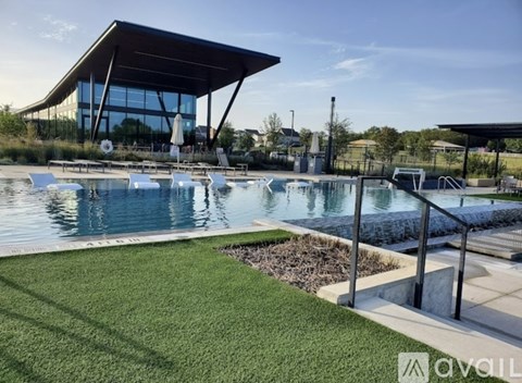 A modern building with a pool in front of it.