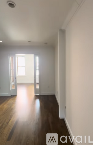 A room with wooden floors and white walls.