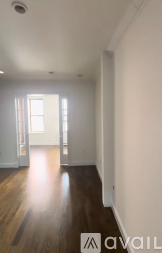 A room with wooden floors and white walls.
