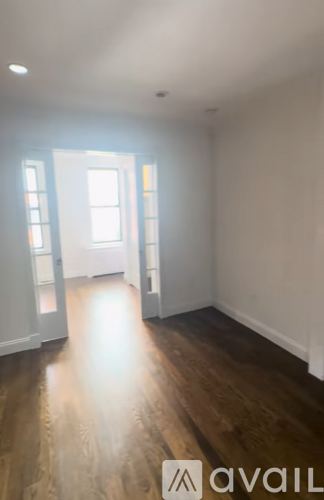 A room with wooden floors and white walls.