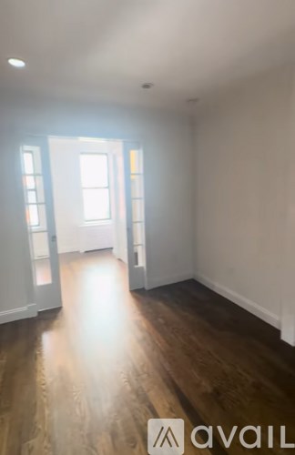 A room with wooden floors and white walls.