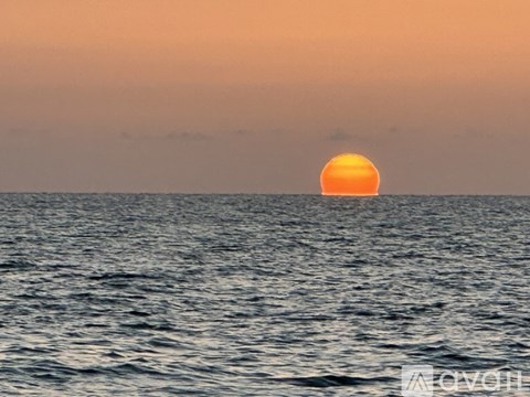 The sun is setting over the ocean.