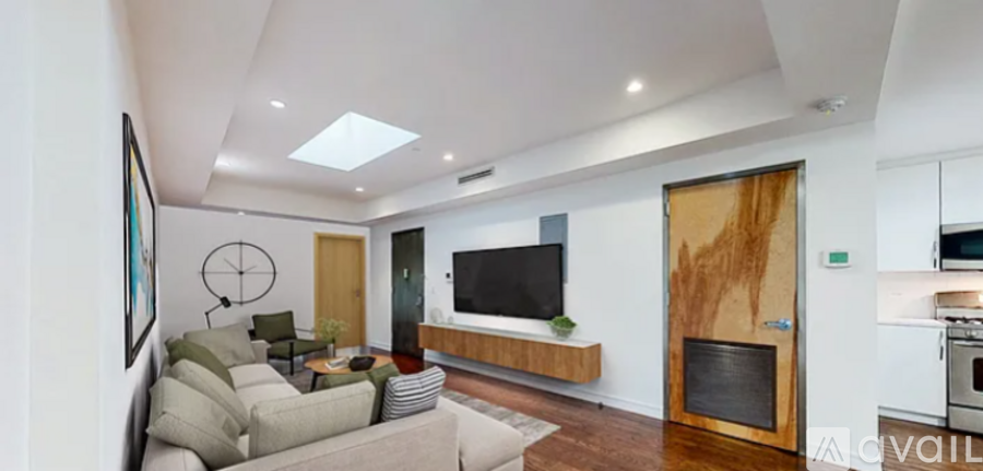 A modern living room with a fireplace and a flat screen TV.
