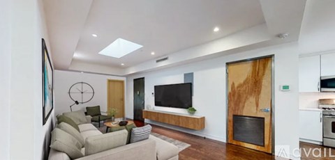 A modern living room with a fireplace and a flat screen TV.