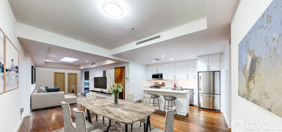 A modern kitchen with a dining table and chairs.