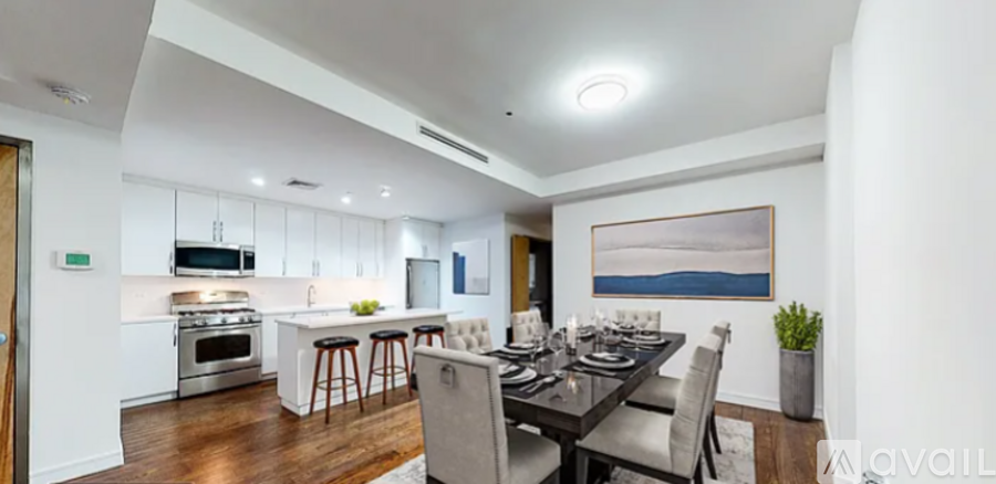 A modern kitchen with a dining table set for four.