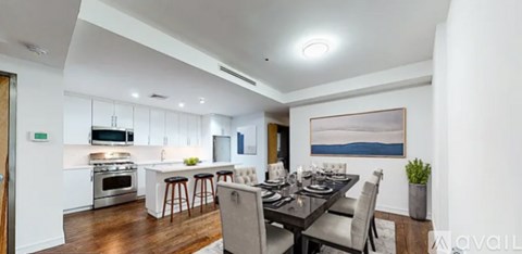 A modern kitchen with a dining table set for four.