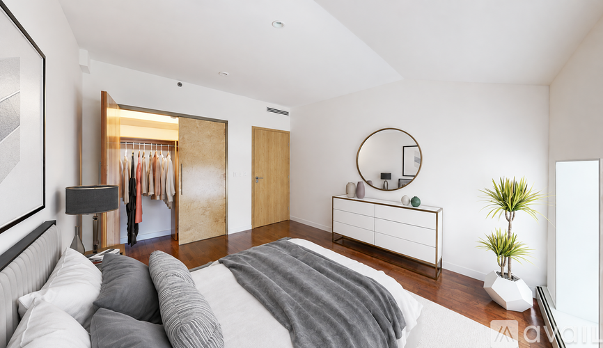 A bedroom with a bed, a dresser, and a mirror.
