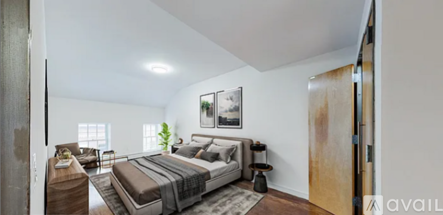 A bedroom with a large bed and a couch.
