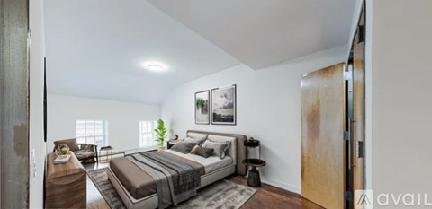 A bedroom with a large bed and a couch.