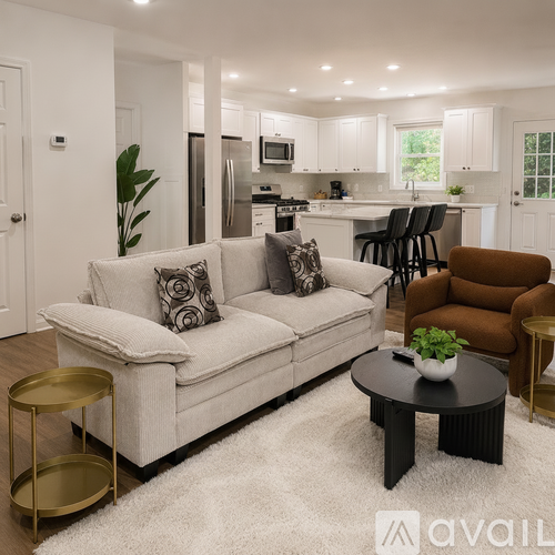 A modern living room with a white couch and a coffee table.