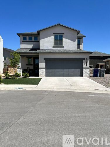 A two-story house with a garage is shown in the image.