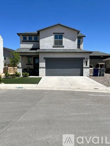 A two-story house with a garage is shown in the image.