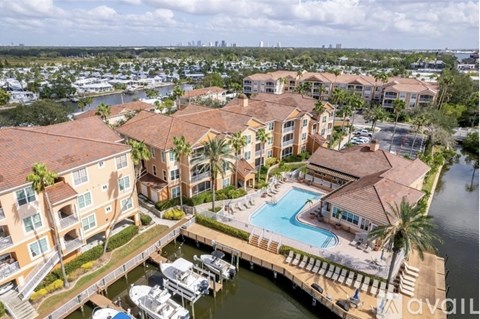 A marina with boats and apartment buildings.