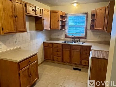 A kitchen with wooden cabinets and a white countertop.